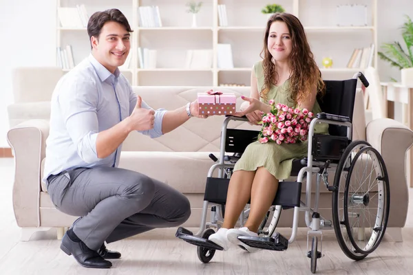 Man making marriage proposal to disabled woman on wheelchair