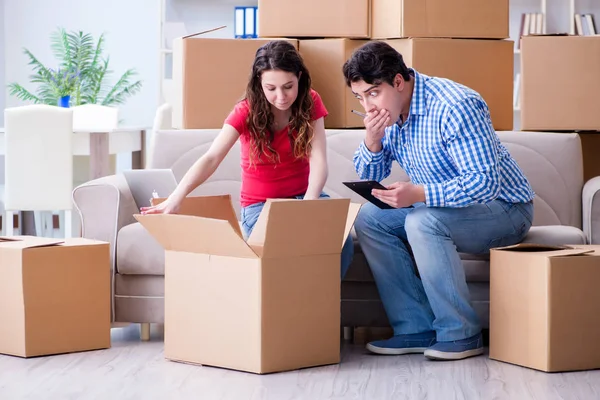 Jovem casal se mudando para casa nova com caixas — Fotografia de Stock