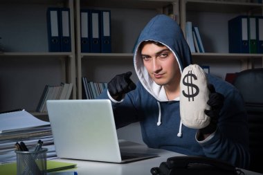 Genç hacker geceleri bilgisayarı hackliyor.