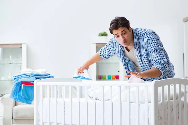 Young dad looking after newborn baby