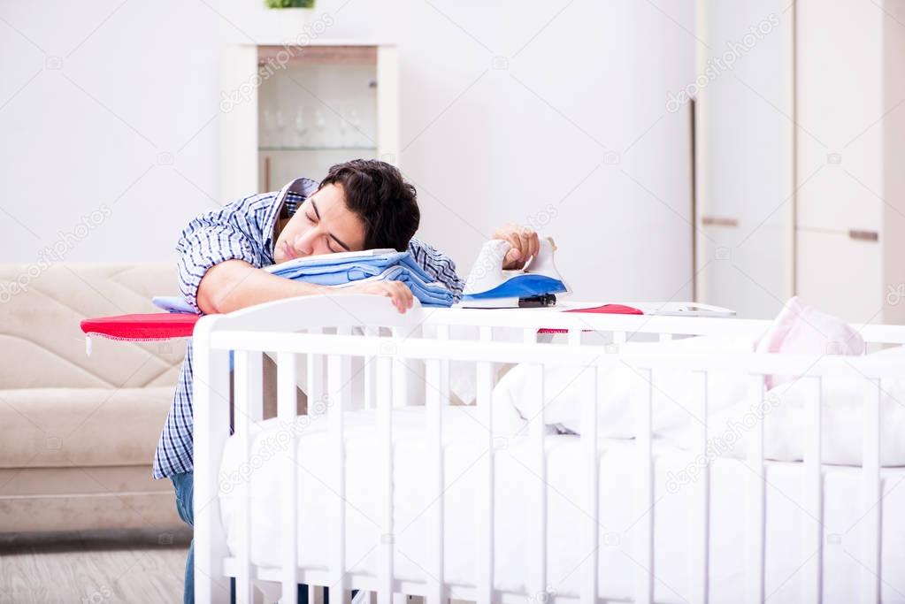 Young dad looking after newborn baby