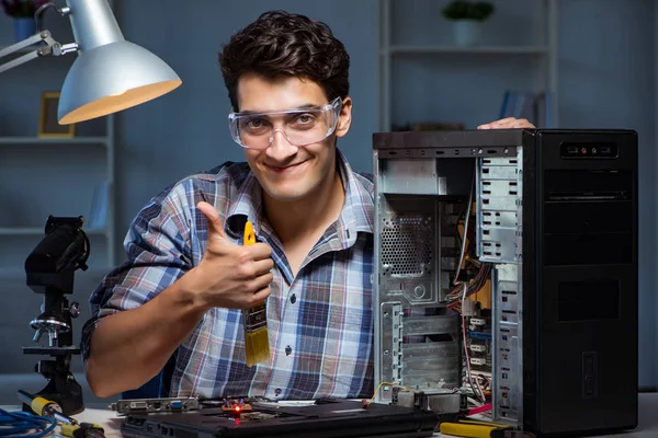 Computer repair man cleaning dust with brush