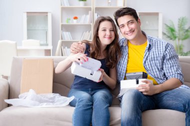 Genç bir aile sanal gerçeklik gözlükleriyle oyun oynuyor.