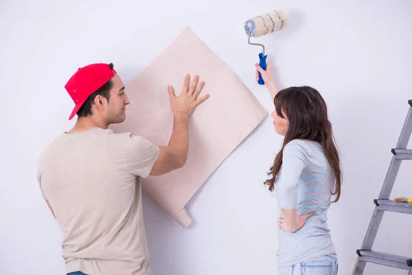 Young family doing renovation at home with new wallpaper — Stock Photo, Image