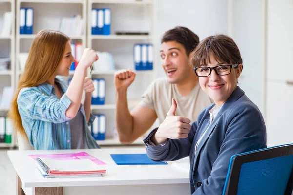 Young family agreeing mortgage contract in the bank for new house