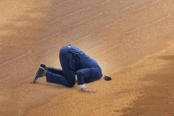 Businessman hiding his head in sand escaping from problems