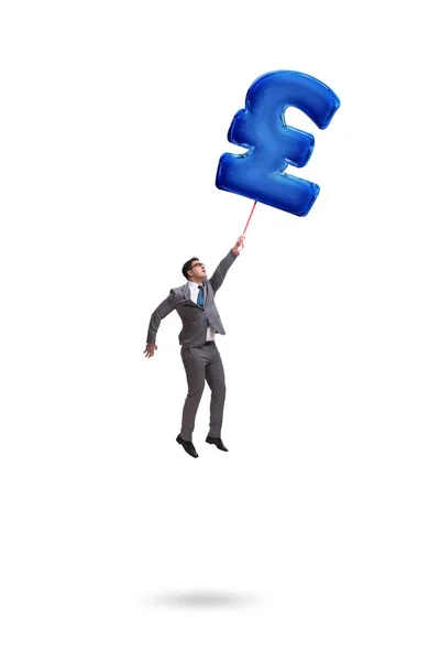 Businessman flying on british pound sign inflatable balloon — Stock Photo, Image