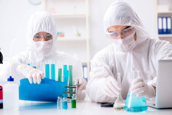 Two chemists working in the lab