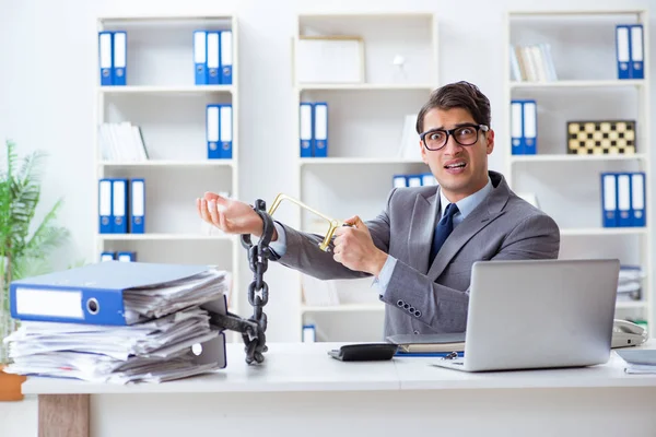 Busy employee chained to his office desk