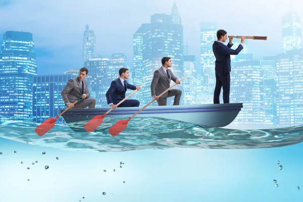 Team of businessmen in teamwork concept with boat — Stock Photo, Image