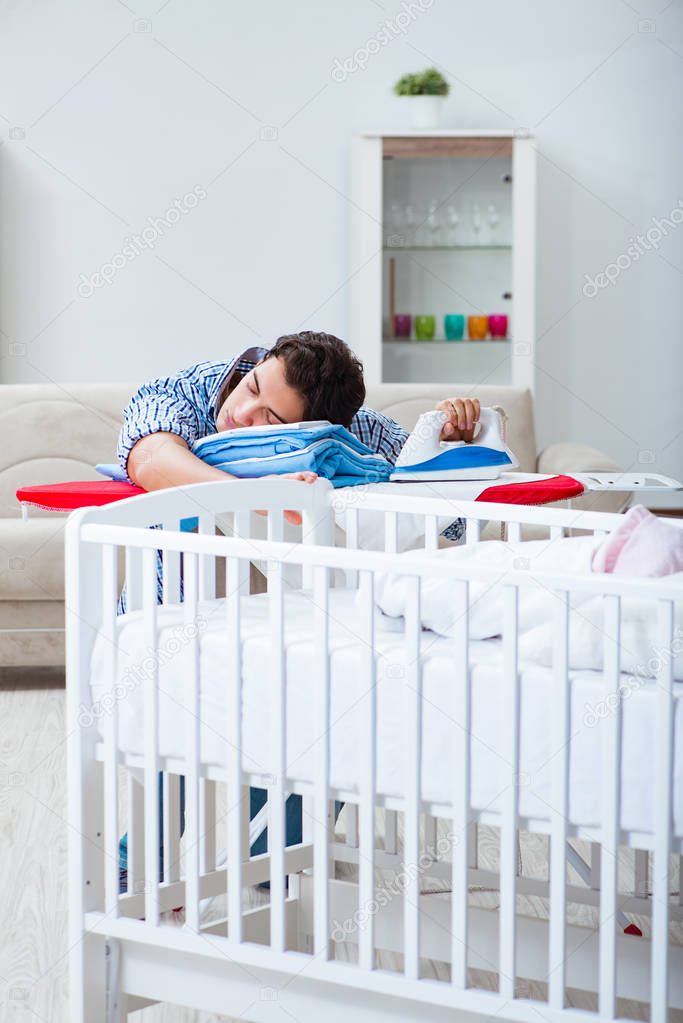 Young dad looking after newborn baby