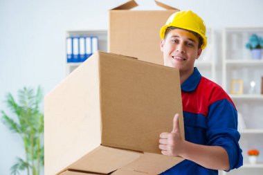 Young man working in relocation services with boxes clipart