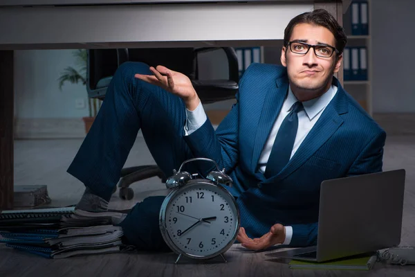 Businessman working overtime long hours late in office