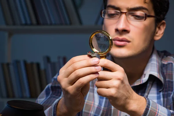 Young male jeweller working at night in his workshop — Stock Photo, Image