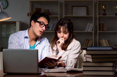 İki öğrenci geç saatlere kadar çalışıp sınavlara hazırlanıyor.