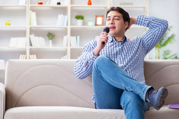 Funny man singing songs in karaoke at home