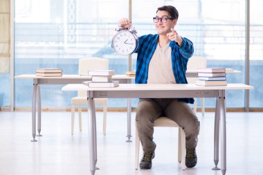 Üniversitede sınava hazırlanmak için zamanı tükenen bir öğrenci.