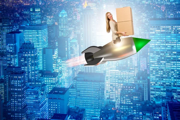 Woman in fast box delivery service on rocket — Stock Photo, Image