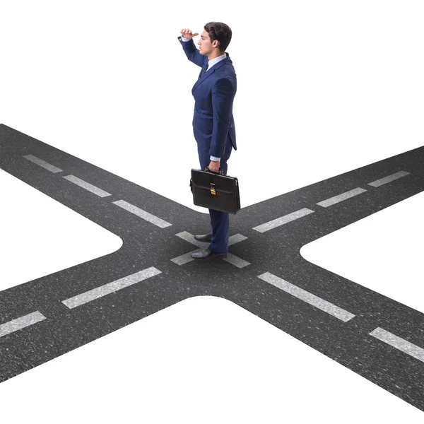 Young businessman at crossroads in uncertainty concept — Stock Photo, Image