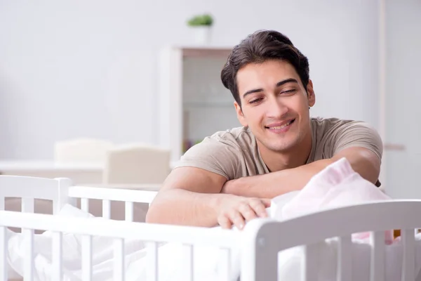 Jonge vader genieten van tijd met pasgeboren baby thuis — Stockfoto