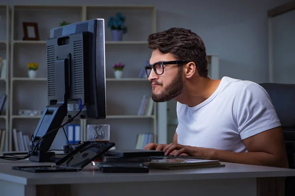Ung man som stannar sent för att jobba övertid — Stockfoto
