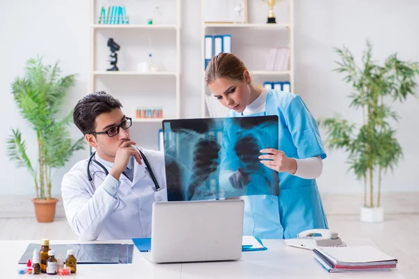 Δύο γιατροί που εξετάζουν ακτινογραφίες ασθενών για διάγνωση — Φωτογραφία Αρχείου