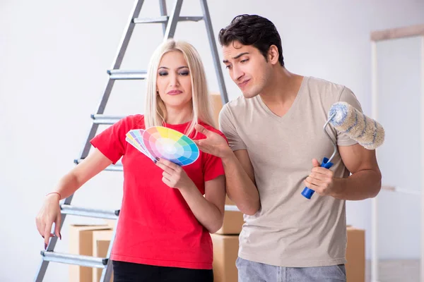 Young family doing painting job during home renovation