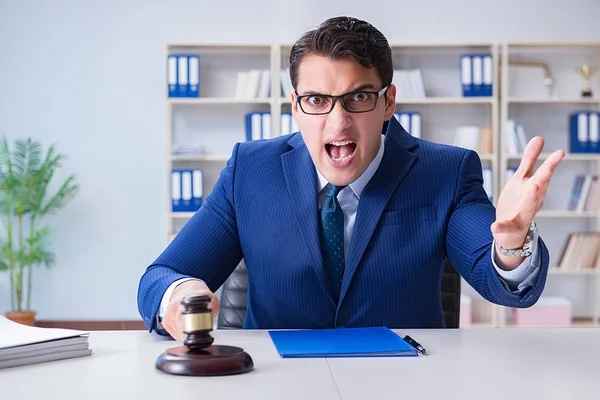 Young lawyer judge sitting in the office