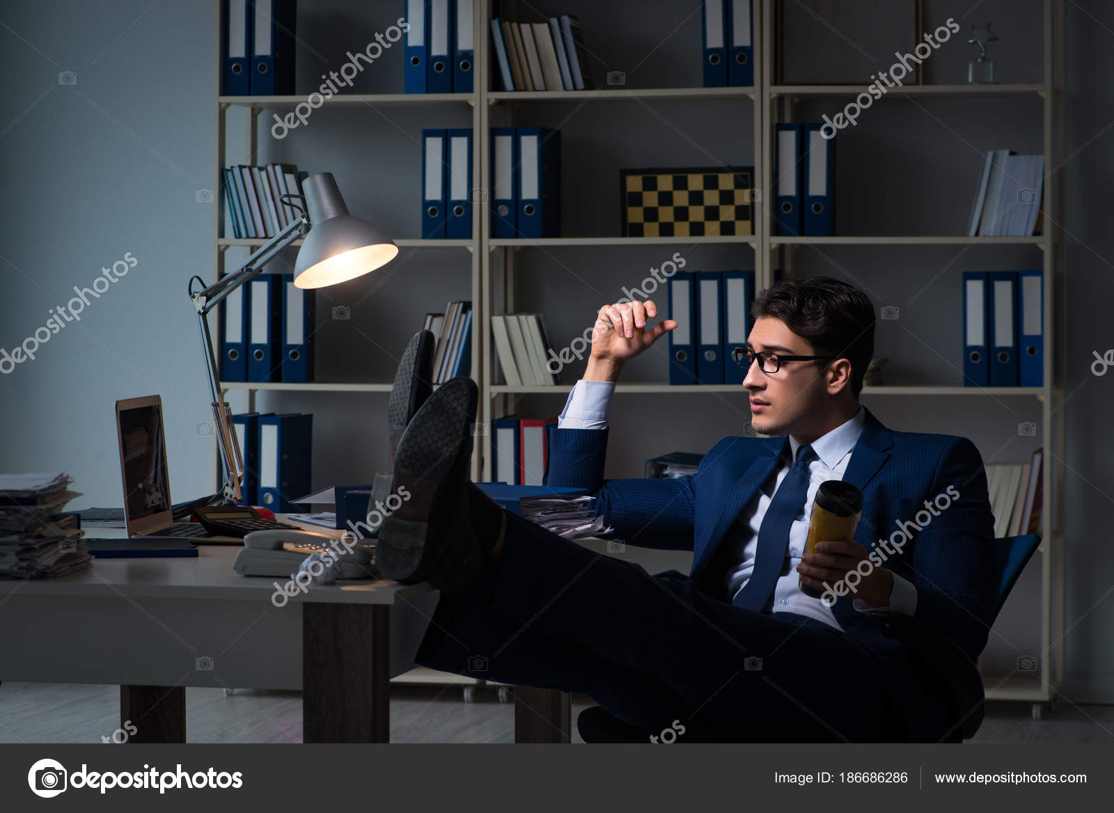 Employee Working Late And Drinking Strong Coffee To Stay Awake