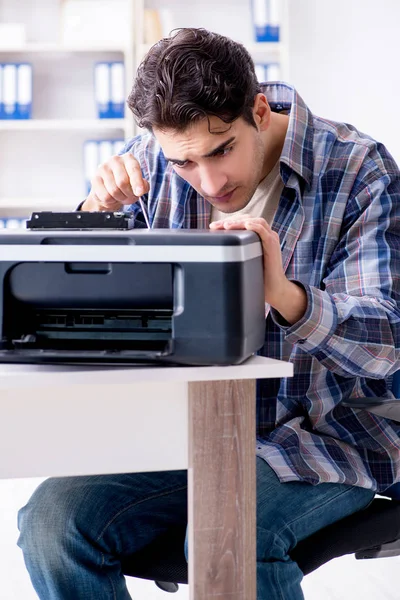 Hardware repairman repairing broken printer fax machine