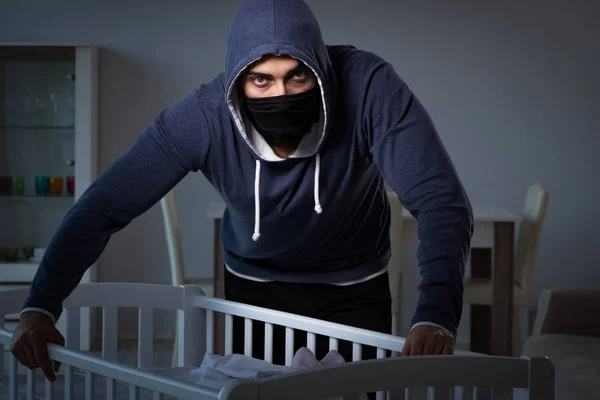 Criminal stealing baby in human child traficking concept — Stock Photo, Image