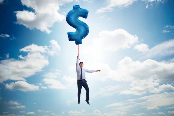 Affärsman som flyger på dollartecken uppblåsbar ballong — Stockfoto