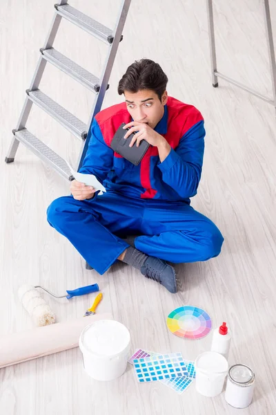 Young painter trying to match colours for painting job — Stock Photo, Image