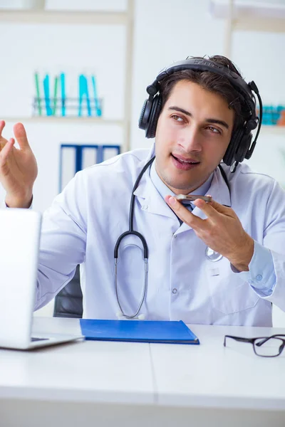 Male doctor listening to patient during telemedicine session — Stock Photo, Image