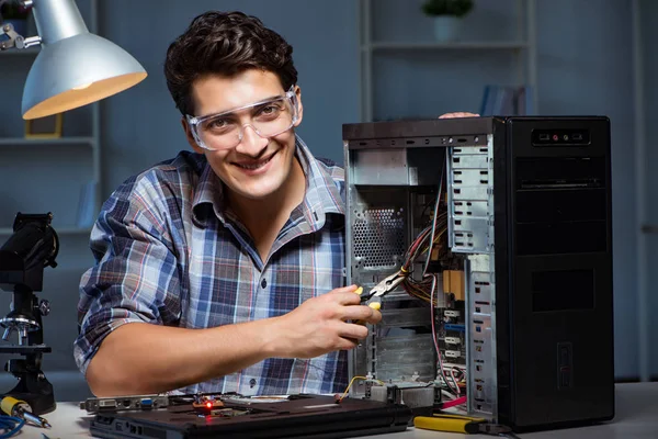 Man repairing computer desktop with pliers