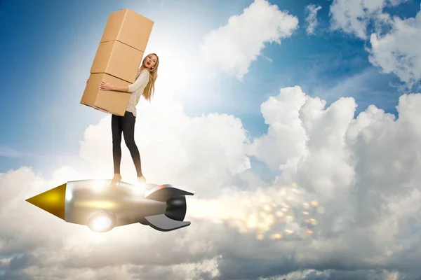 Woman in fast box delivery service on rocket — Stock Photo, Image
