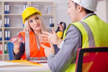 Construction workers having discussion in office before starting clipart