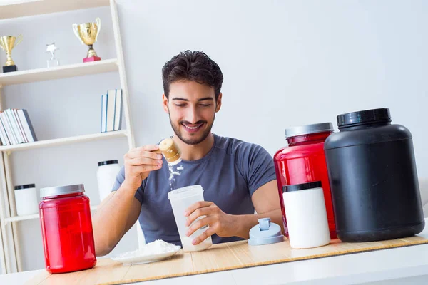 Athlete tasting new protein supplements for better muscles — Stock Photo, Image