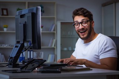 Genç adam fazla mesai yapmak için geç saatlere kadar ofiste kalıyor.