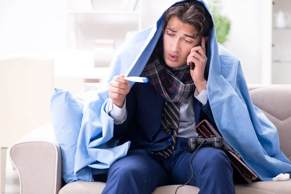 Employee suffering from flue playing computer game at home — Stock Photo, Image