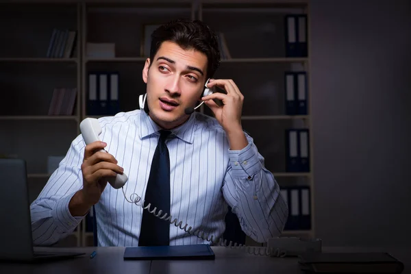 Call center operator talking to customer during night shift