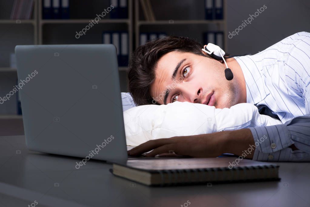 Tired and exhausted helpdesk operator during night shift