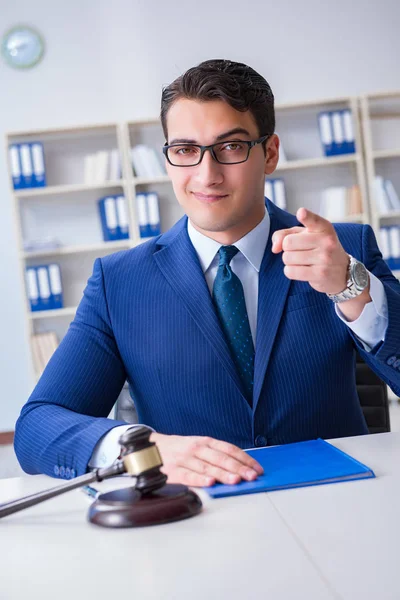 Young lawyer judge sitting in the office