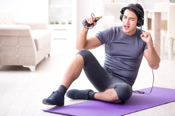 Man doing sports at home and listening to music