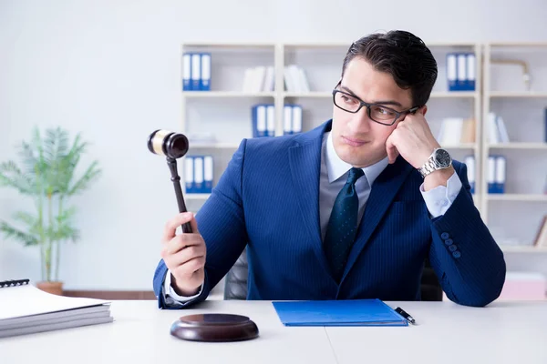 Young lawyer judge sitting in the office