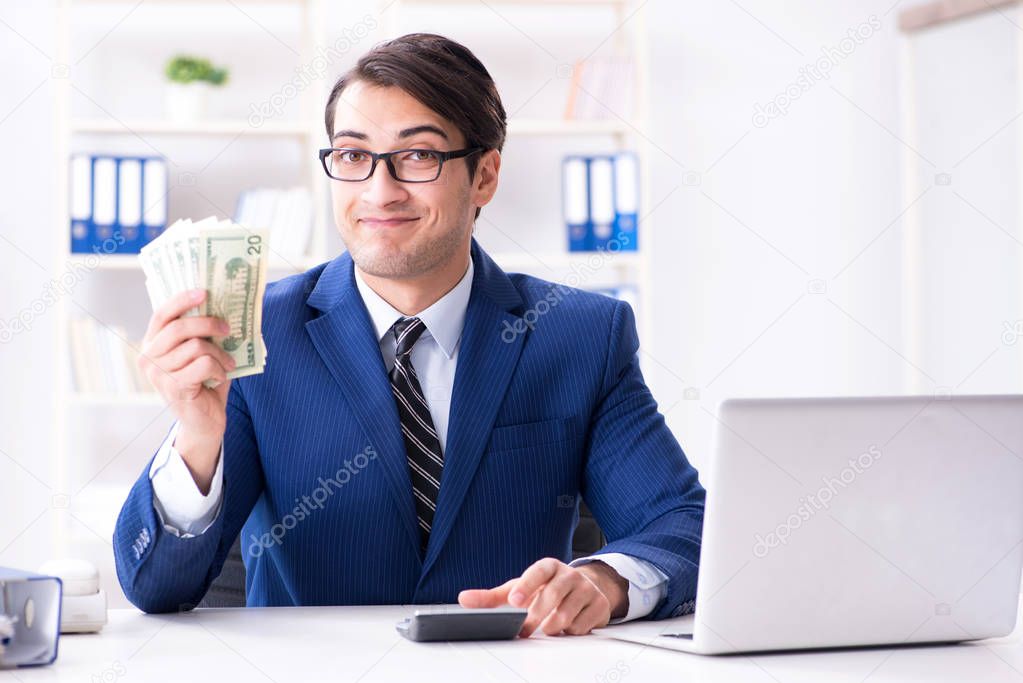 Accountant calculating dollars with calculator in office