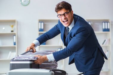 Businessman making copies in copying machine clipart