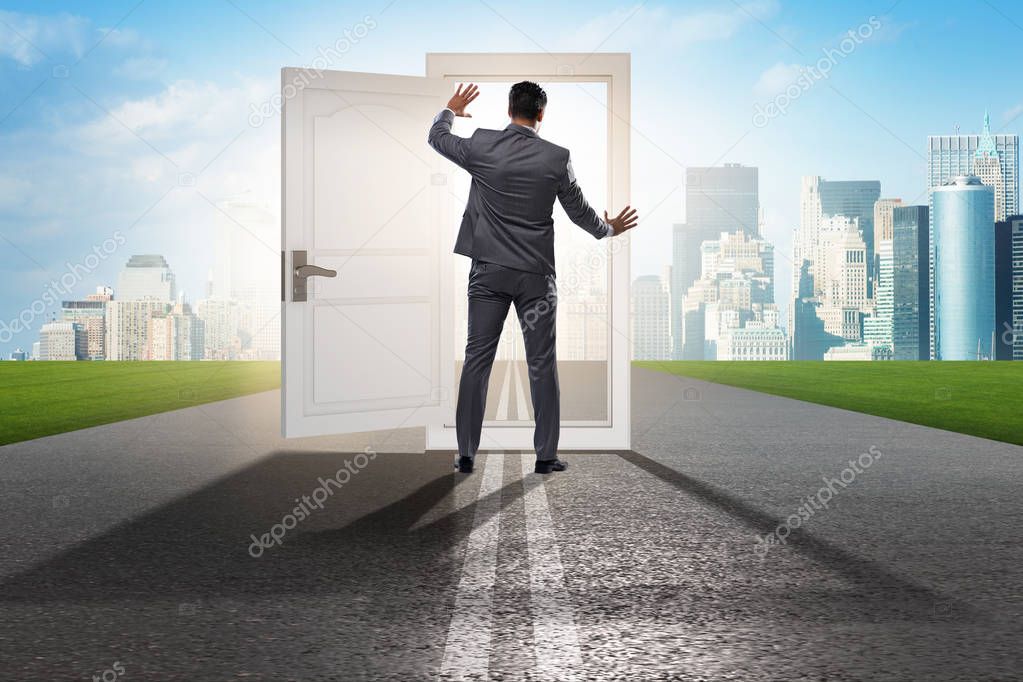 Businessman in front of door in business opportunities concept