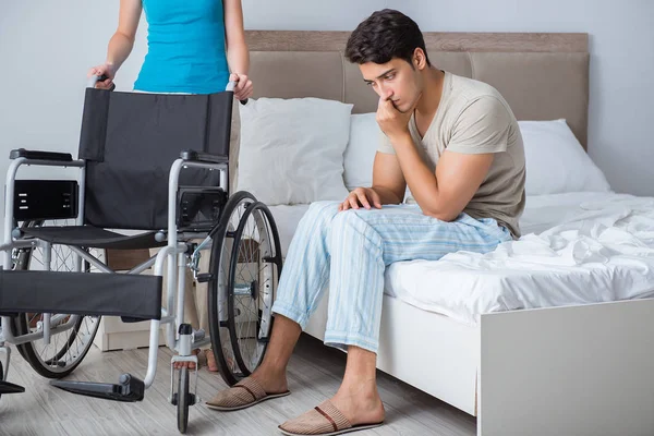 Desperate man on wheelchair with his sad wife