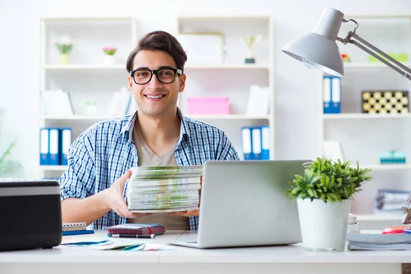 Sales assistant at publishing house showing ready printed books